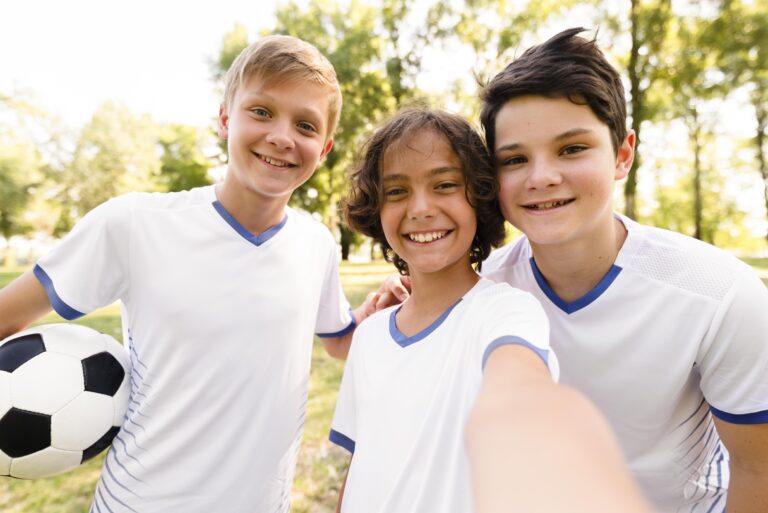 front-view-kids-football-sportswear-taking-selfie